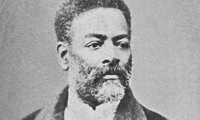 Retrato histórico de um homem com barba e cabelo cacheado, representando a luta e a resistência. Uma figura importante na história do Brasil.